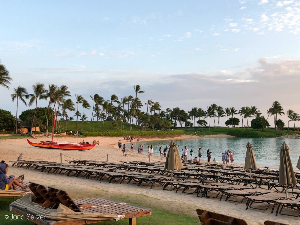 sunset at the ocean front at Disney Aulani with beach chairs