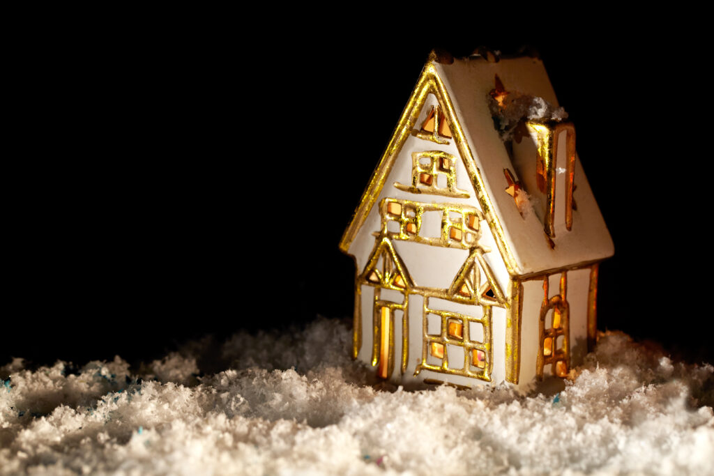 Little toy house covered with artificial snow.