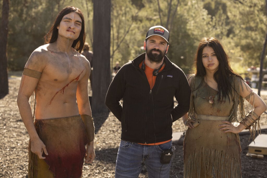 Dakota Beavers as Taabe, Director Dan Trachtenberg, and Amber Midthunder as Naru